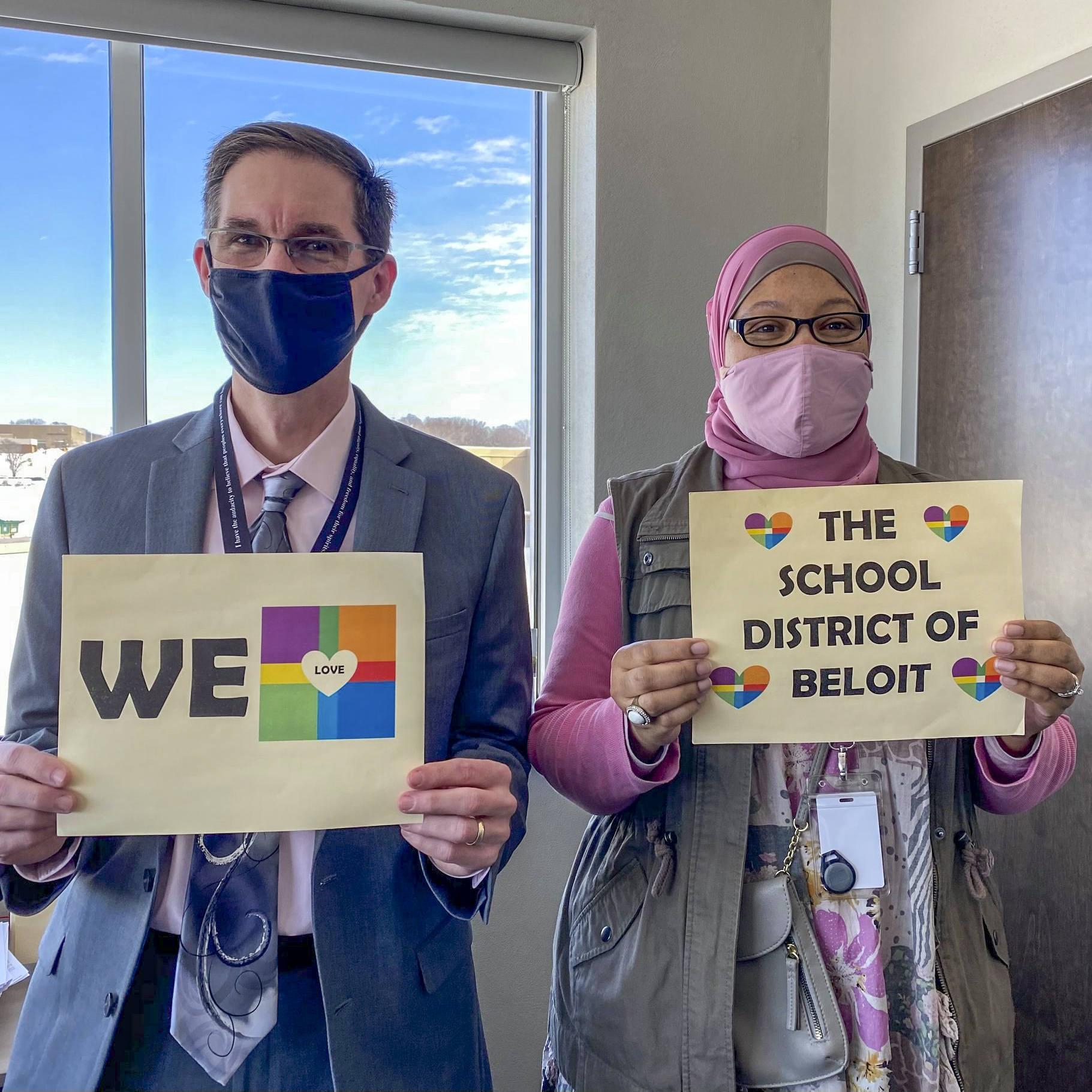 Dr. Keyser and Ms. Donna holding a We love the School District of Beloit sign